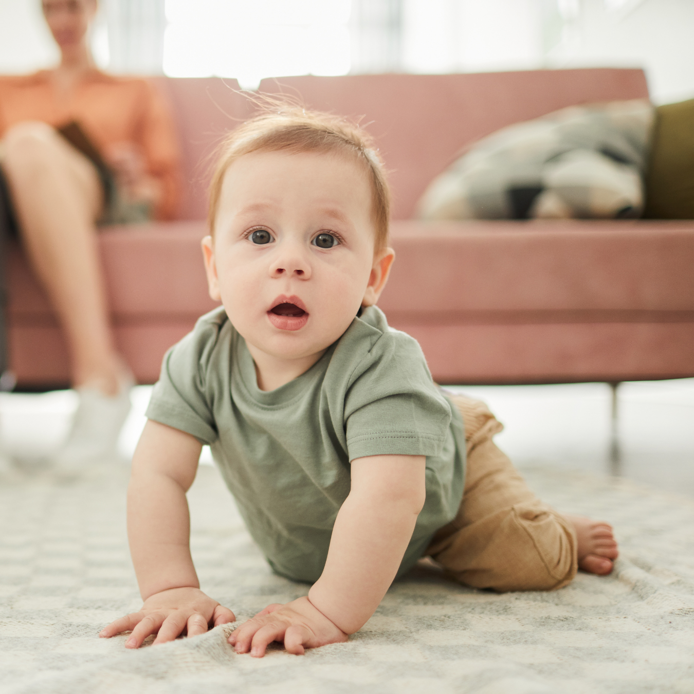 Baby crawling on a soft floor while exploring indoors