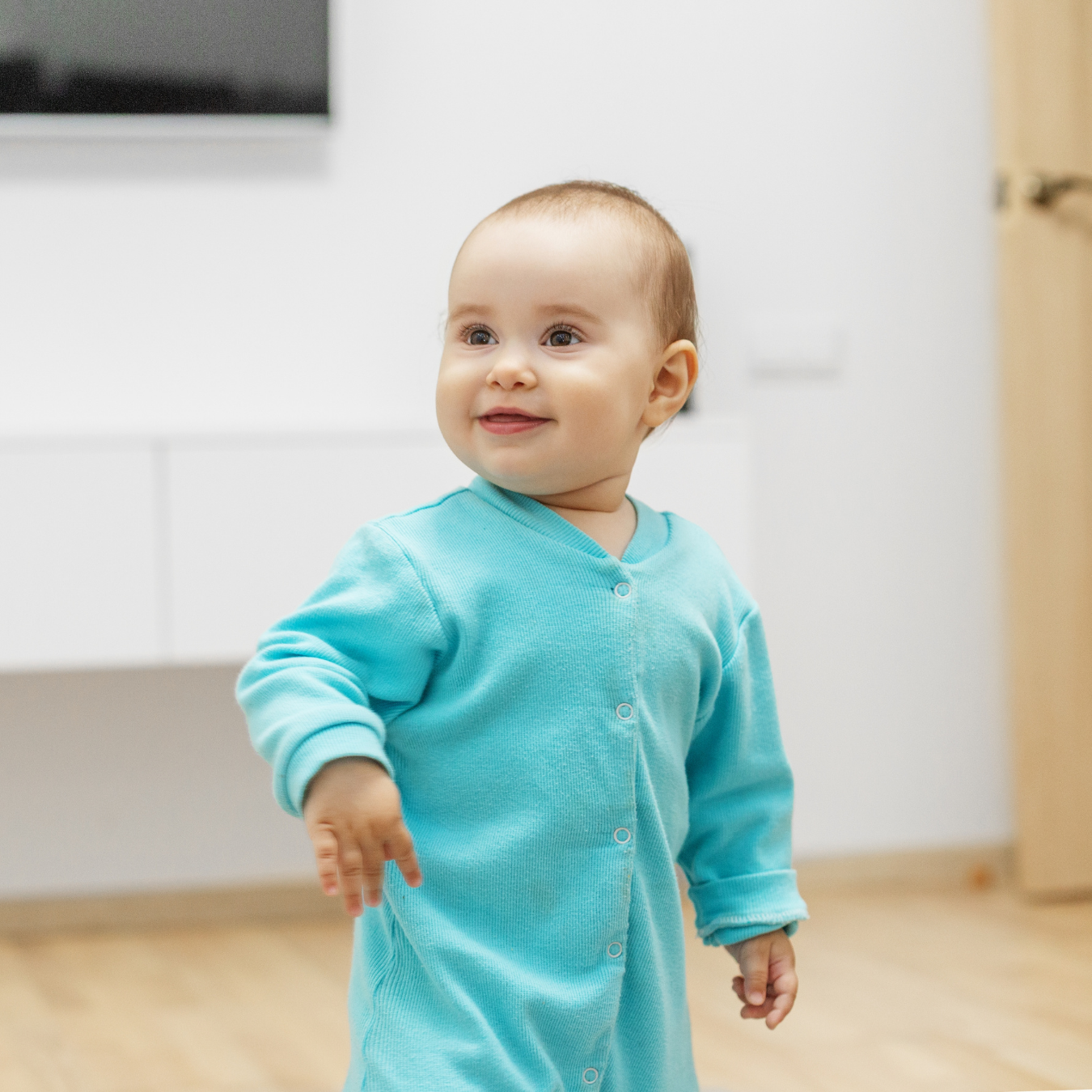 Smiling baby dressed in a soft cotton outfit for comfort